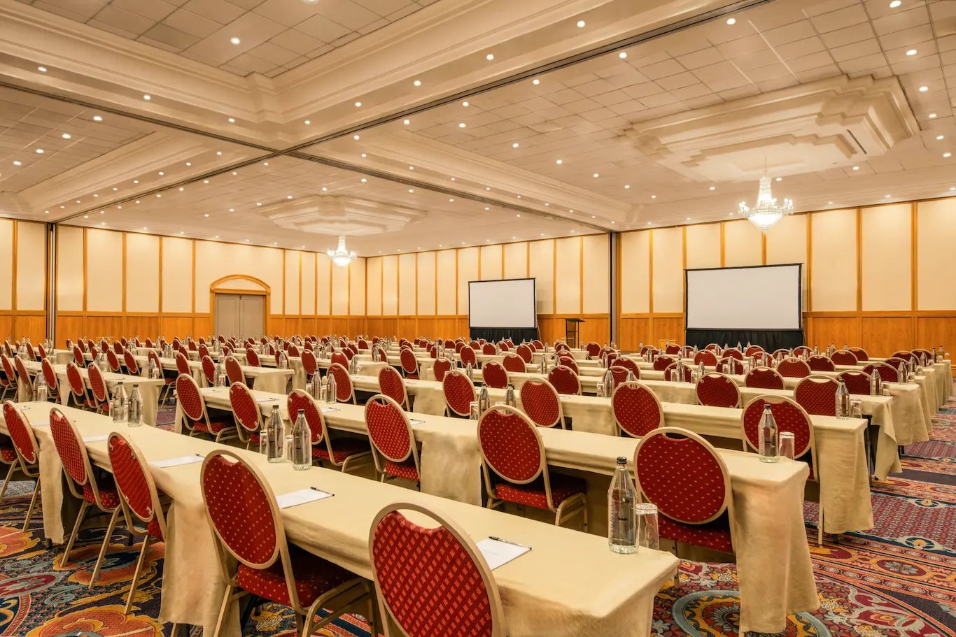 Grand ballroom at the Windhoek International Convention Centre set up in classroom style with twin projection screens, ready for a large conference or plenary session supported by Conference Rentals